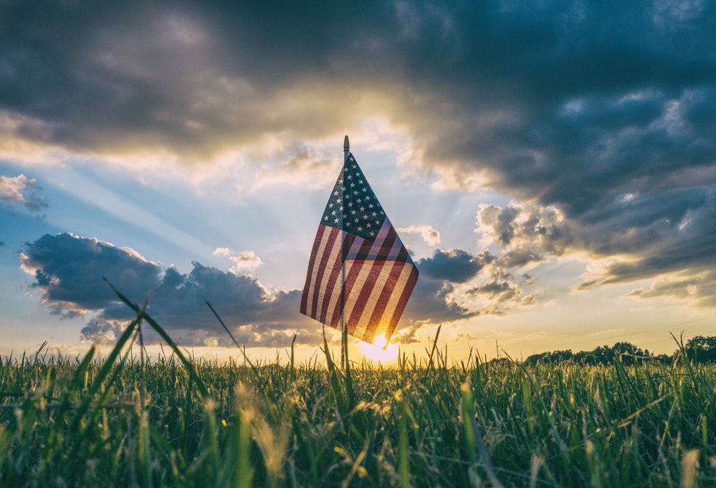 An American flag in a grass field.